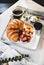 French breakfast with croissant, berries and coffee in cafe