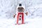 French Bulldog dog dressed up as snowman with funny full body suit costume with red scarf, fake stick arms and small top hat