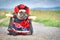 French Bulldog dog dressed up with `La Catrina` Halloween costume with red and black dress with rose flowers and lace veil