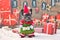 French Bulldog dog wearing funny traditional cute christmas elf costume with arms holding present and Santa hat