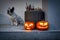 French Bulldog with the scary Halloween pumpkins as decoration on the front steps