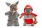 French Bulldogs dressed up as Little Red Riding Hood and bad wolf with full body dog Halloween costumes on white background