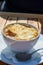 French caramelized onion soup with croutons and gruyere cheesse from oven