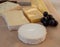 French cheese collection on marble board, emmental, carre de aurillac, petit cantal AOP Jeune, buche chevre, brie