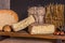 French cheese Saint Nectaire rustic collection delicious. Black background.