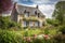 french country house exterior with flowering garden and butterfly