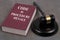 French criminal procedure code book with a judge gavel