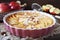 French cuisine. Red apple clafoutis, almonds and powdered sugar dressing