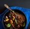 French cuisine: steamed muscles with fresh basil leaves in a black pot together