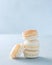 French dessert Stack Macaron shells ready to be filled over light background, copy space. Cooking, food and baking concept