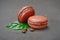 French dessert. Sweet brown chocolate macaroons or macarons with coffee flavor and beans