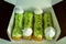 French dessert. Tasty lime eclairs with meringue in the box