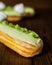 French dessert. Tasty lime eclairs with meringue on the table