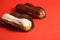 French desserts eclairs with white chocolate and dark chocolate on top filled with custard served on red background