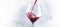 French dry red wine, pours into glass, gray background, banner,