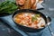 French fish soup Bouillabaisse with seafood, salmon fillet, shrimp, rich flavor, delicious dinner. Close up