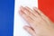 French flag and hand on it. patriotism and loyalty concept