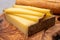 French food -  piece of cheese comte made from cow milk in region Franche-Comte in France and fresh baked baguette bread