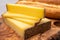 French food -  piece of cheese comte made from cow milk in region Franche-Comte in France and fresh baked baguette bread