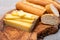 French food -  piece of cheese comte made from cow milk in region Franche-Comte in France and fresh baked baguette bread