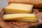 French food -  piece of cheese comte made from cow milk in region Franche-Comte in France and fresh baked baguette bread