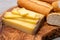 French food -  piece of cheese comte made from cow milk in region Franche-Comte in France and fresh baked baguette bread