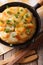 French food: Potato gratin in a pan close-up. vertical top view