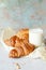 French fresh crispy croissant with a glass of milk for breakfast, selective focus