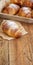 French fresh crusty croissants on a wooden table