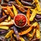 French fries,  baked fries from different types and colors of potatoes sprinkled with herbs and spices with spicy tomato sauce