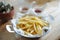 French fries in dish on the table, focusing