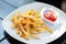 French fries, forks, table. French fries on an outdoor cafe table