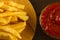 French fries with fresh ketchup an cutting Board