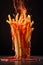 French fries with hot spicy ketchup burning with flames and fire. Chili spiced food. Generative Ai