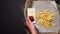 French fries with ketchup and cheese sauce on a dark table, top view. flat lay