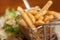 French fries in little metallic basket in a plate at
