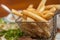 French fries in little metallic basket in a plate at