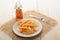 French fries on a paper plate and malt vinegar