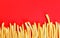 French fries on a red background, top view. Roast potatoes, copy space