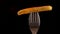 French fry on a fork with a stripe of ketchup rotate