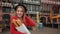 French girl in black beret holding paper-wrapped loaves in her hand smiles,