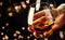 French glowing cognac glass in hand on the dark bar counter background, copy space, selective focus