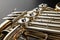 French horn on a wooden table. Beautiful polished musical instrument