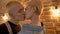 French kiss of young hipster couple, passion, relationship conception, love conception, brick background, closse-up