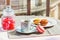 French macarons and a cup of espresso on a balcony.