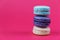 French macarons. Sweet colorful bisquits. Front view. Copy text space. Hot pink background.