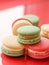 French macaroons on red background, parisian chic cafe dessert, sweet food and cake macaron for luxury confectionery brand,