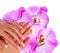 French Manicure. Beautiful Female Hands with pink orchid flowers