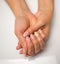 French manicure and nail gel Polish. Young, perfect, groomed woman`s hands with pink and white nail varnish bottles.