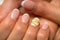 French manicure and nail gel Polish. Young, perfect, groomed woman`s hands with pink and white nail varnish bottles.